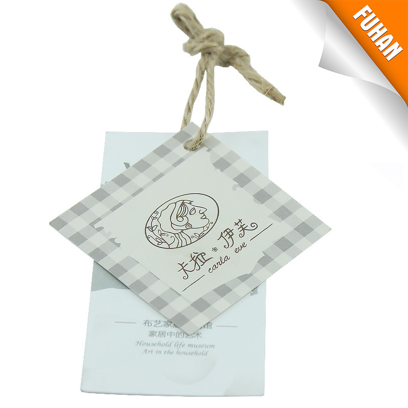 Woven label and paper hang tag with webbing and safety pin